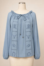 Blue B Western Embroidered Chambray Top embroidered panels with horseshoe cowboy boot bull skull and cowboy hat motifs plus adjustable drawstring tie