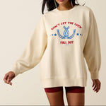 Ariat Womens Oversize Sweatshirt Parchment parchment cream heavyweight cotton fleece sweatshirt with red and blue horseshoe graphic womens western boutique Utah SKU 