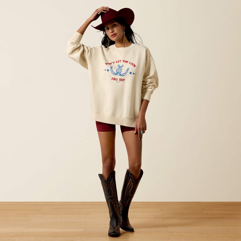 Ariat Womens Oversize Sweatshirt Parchment cozy layer styled with cowboy boots and a felt hat for fall rodeo days in Park City