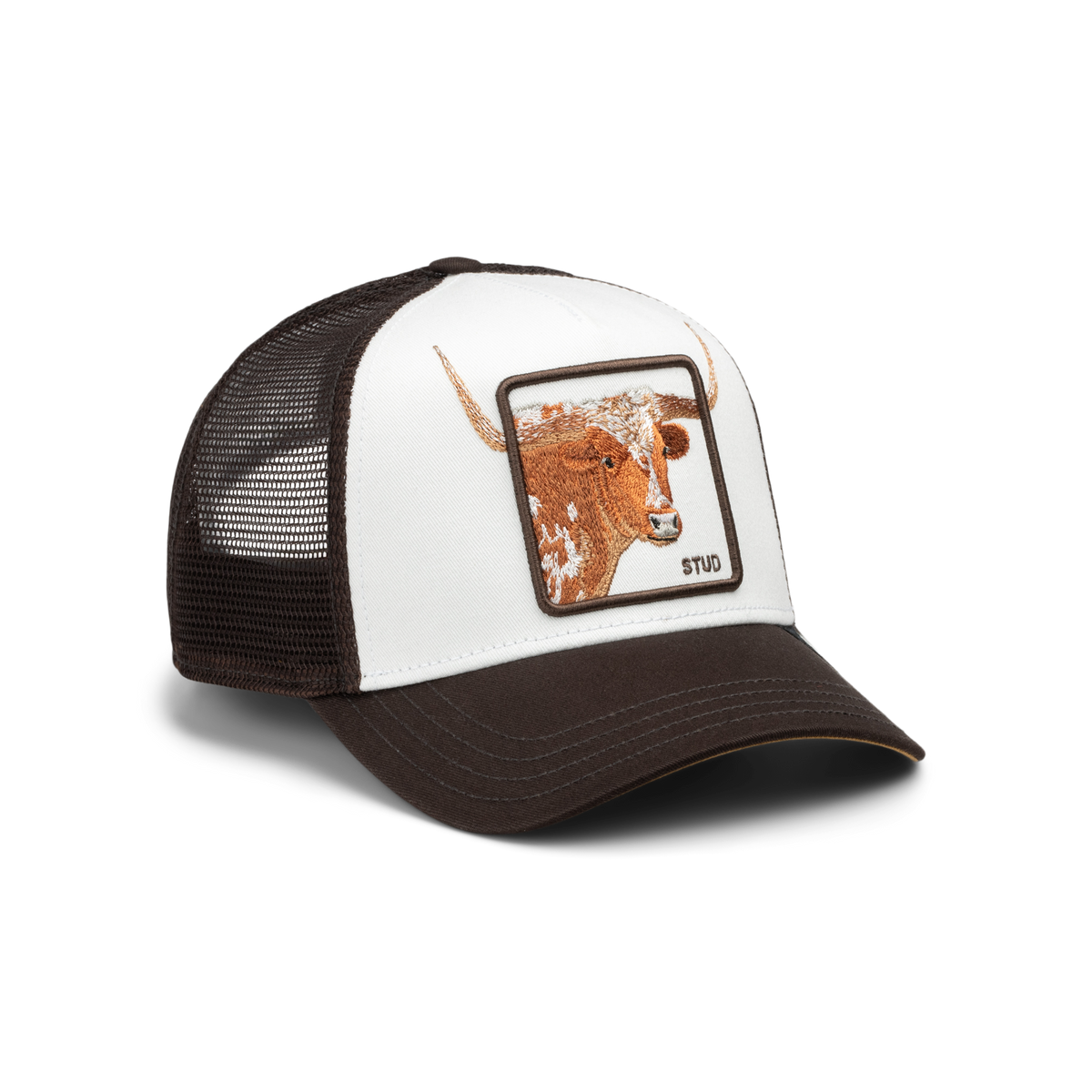 A brown and white trucker hat with a white front panel, dark brown mesh back, and a square patch featuring a brown longhorn steer illustration. The patch has the brand name 'STUD' written on it.