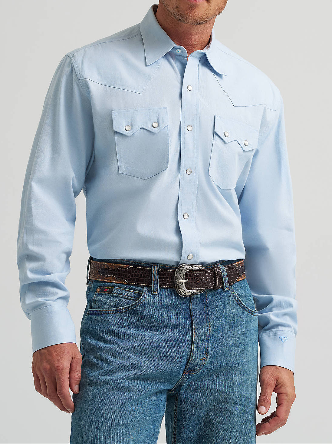 112378949 Wrangler Mens Cody Johnson Two Pocket Western Snap Shirt at boltranchstore.com free shipping Man wearing a light blue shirt, jeans, and a cowboy hat  outfit in stock mens western pearl snap shirt in baby blue