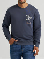 112380291 Wrangler Mens Bucking Rider Graphic Fleece Sweatshirt at boltranchstore.com in stock free shipping A man wearing a navy blue crewneck sweatshirt with a white cowboy graphic and the word 'Wrangler' on the chest