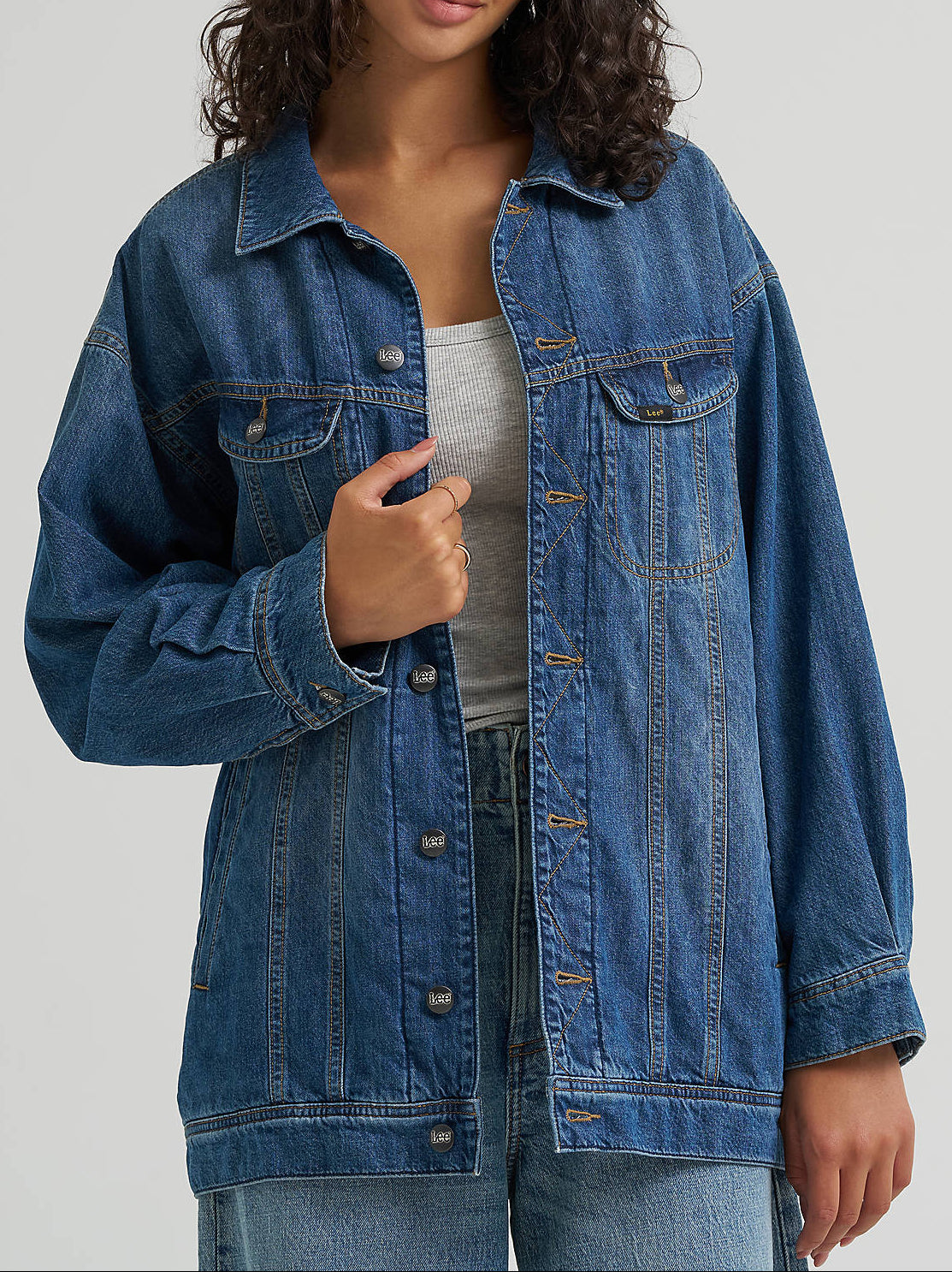 112384098 Lee Womens Oversized Flannel Lined Rider Jacket at boltranchstore.com in stock free shipping A woman wearing an oversized medium-wash blue denim jacket 