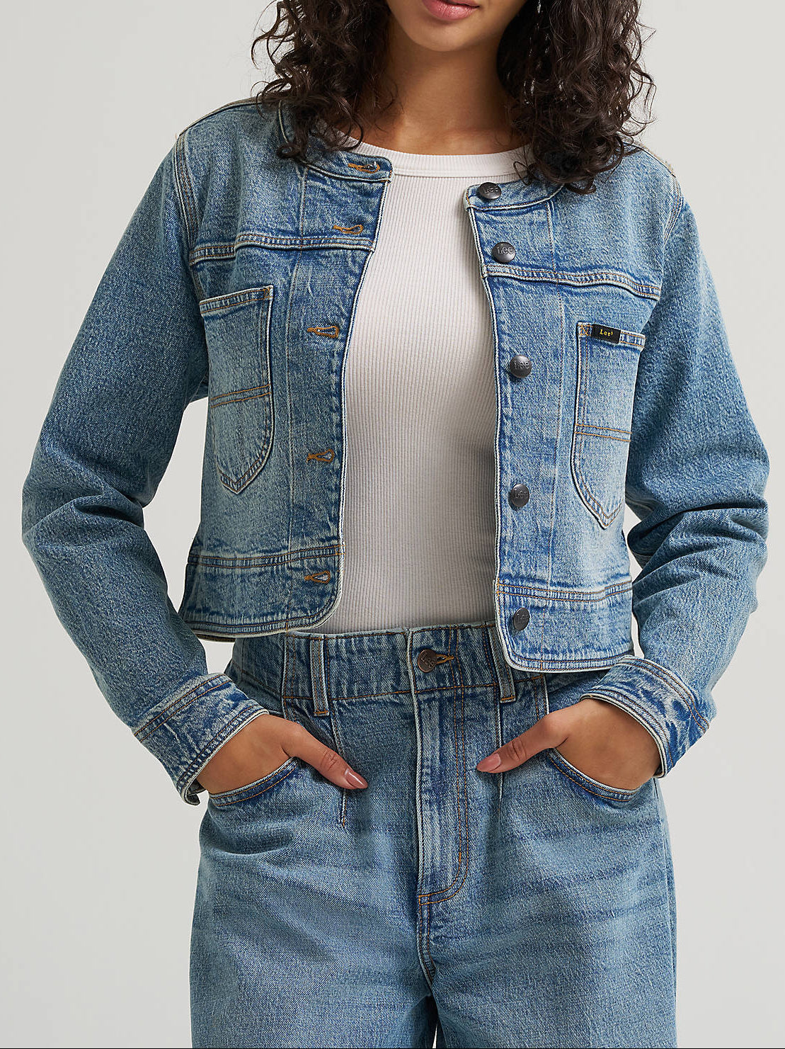 112384099 Lee Womens Cropped Chore Jacket at boltranchstore.com in stock free shipping A woman modeling a cropped light blue denim jacket 
