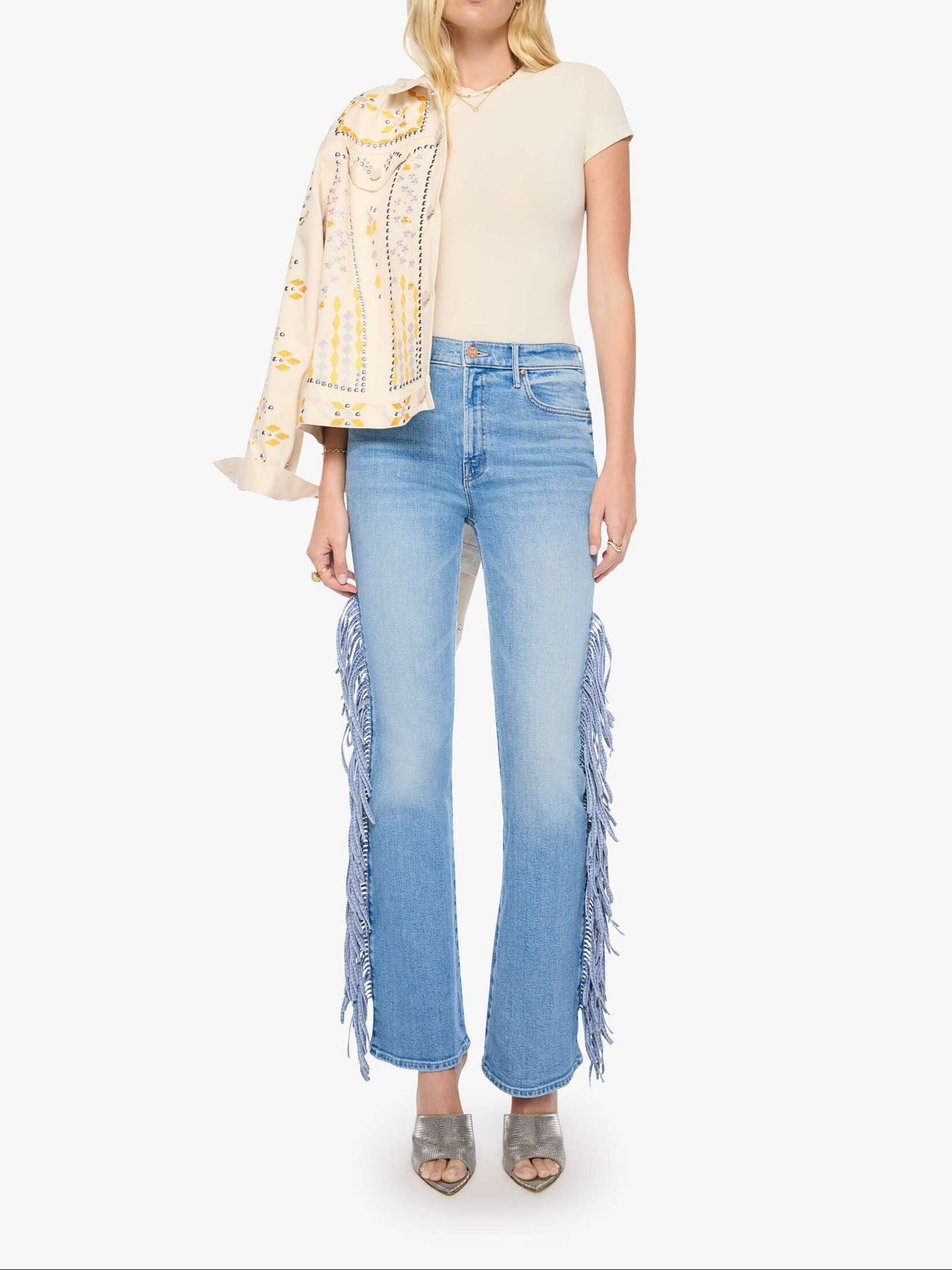 wearing light-wash blue jeans with long fringe detailing down the outer legs womens western jean nfr outfit jeans 11495-1219-Mother The Fringe Desperado Sneak at boltranchstore.com in stock free shipping 