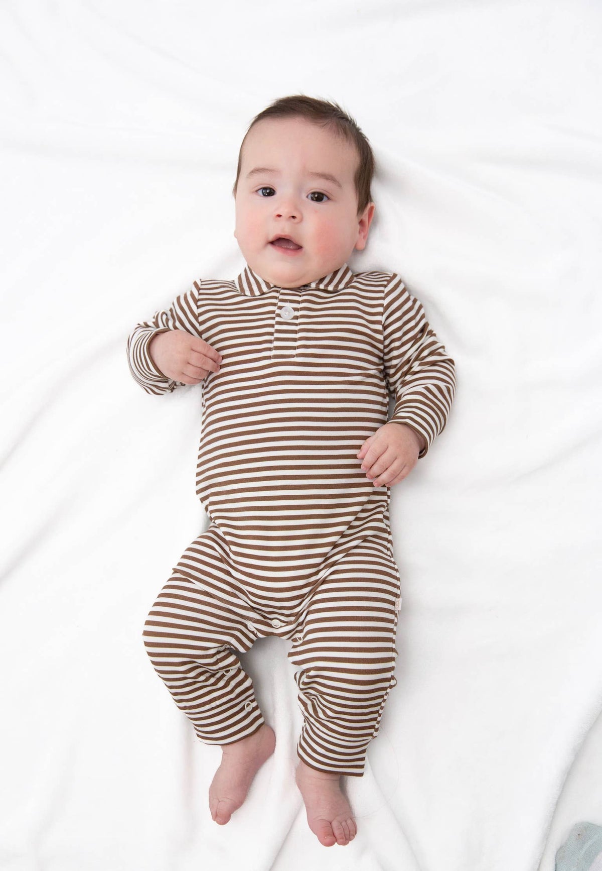 Baby wearing a brown and white striped onesie on a white background shop today at boltranchstre.com