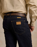 Schaefer Ranch Flex Boot Cut Dungarees Dark Rinse sits over cowboy boots for rodeo and western fashion Park City