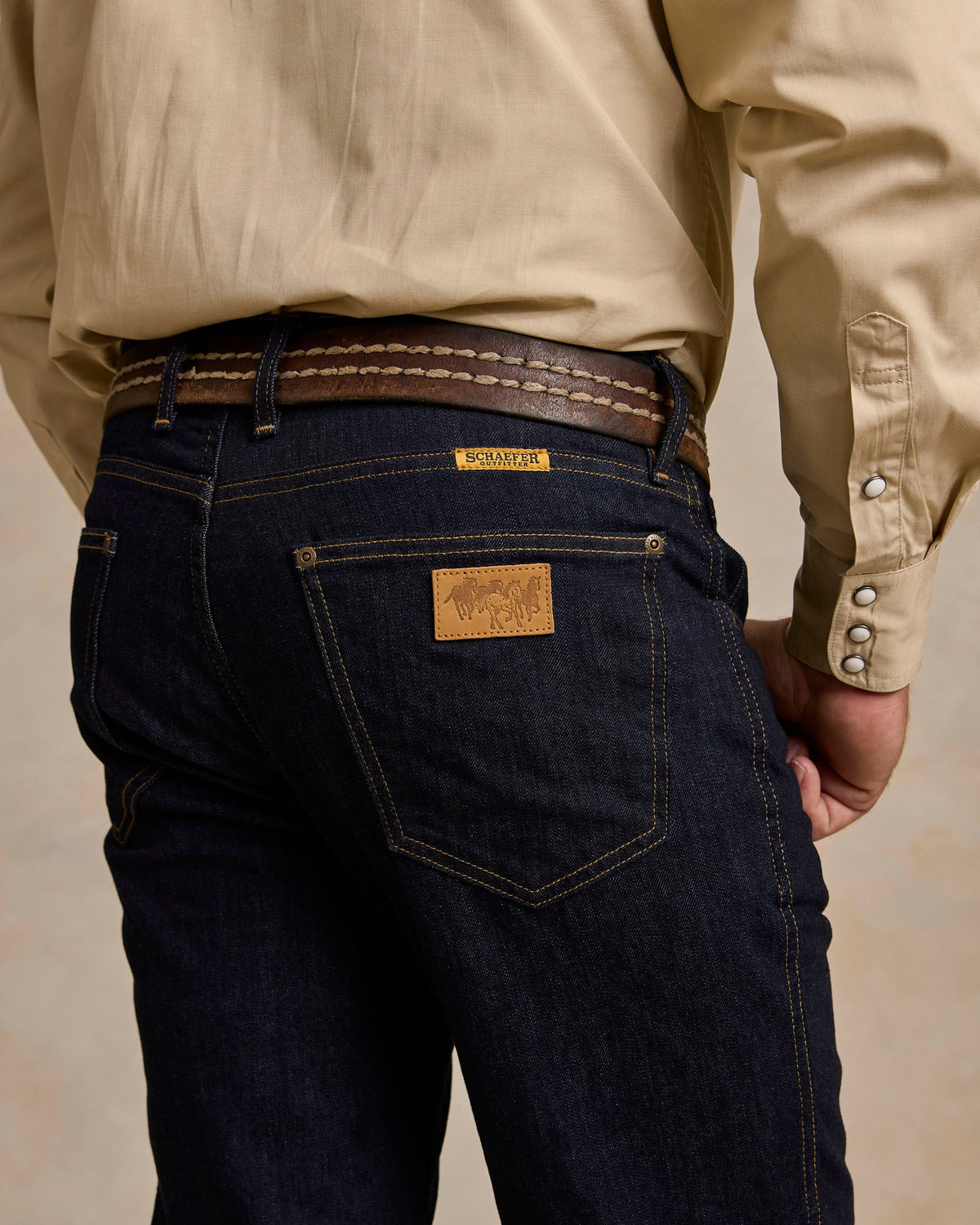 Schaefer Ranch Flex Boot Cut Dungarees Dark Rinse sits over cowboy boots for rodeo and western fashion Park City
