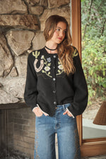 Blue B Western Graphic Sweater Cardigan Charcoal cozy sweater knit worn open with hands in jean pockets rodeo style