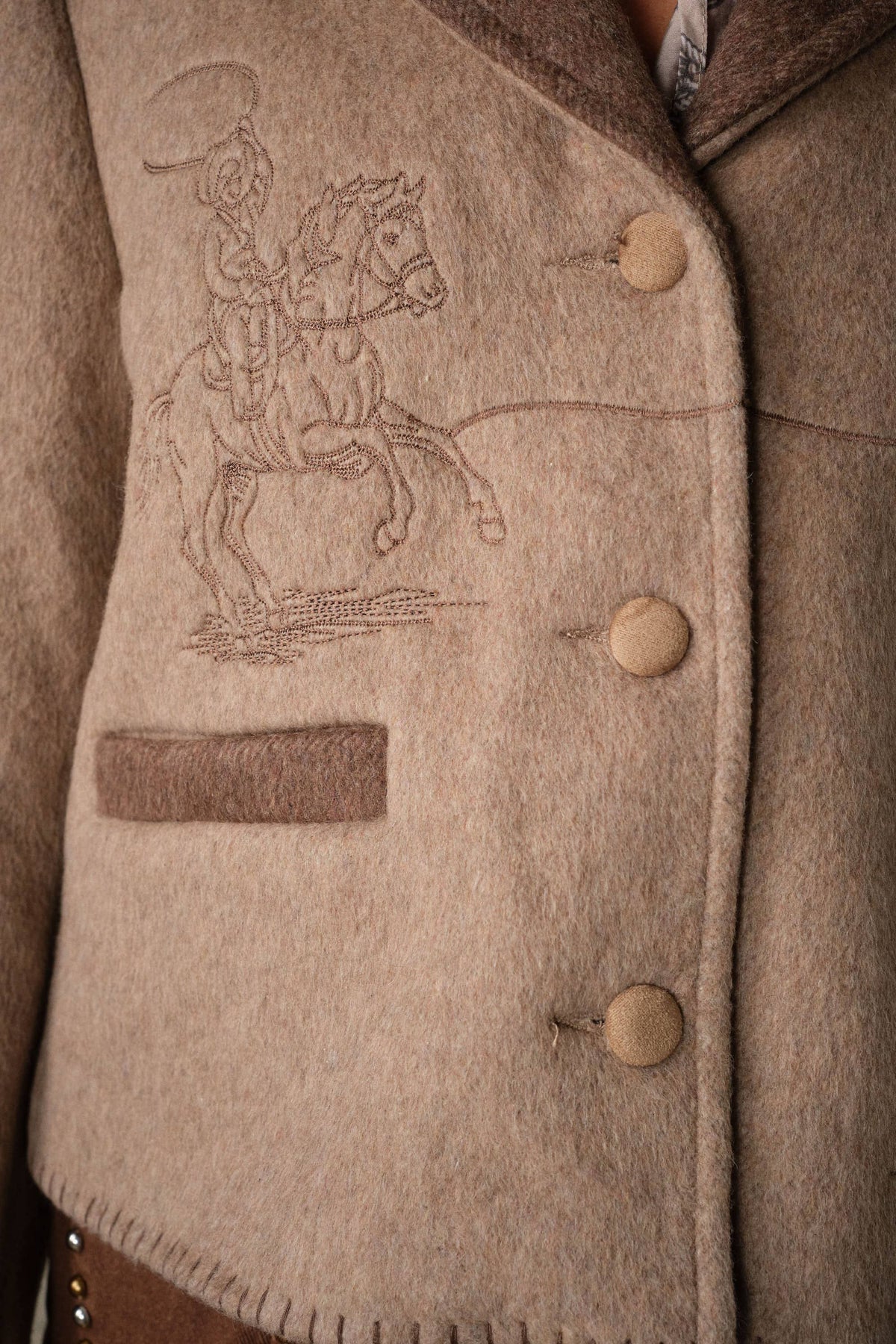 Blue B Western Two Tone Embroidered Jacket Mocha tonal horse and lasso embroidery beside a contrast welt pocket and covered buttons