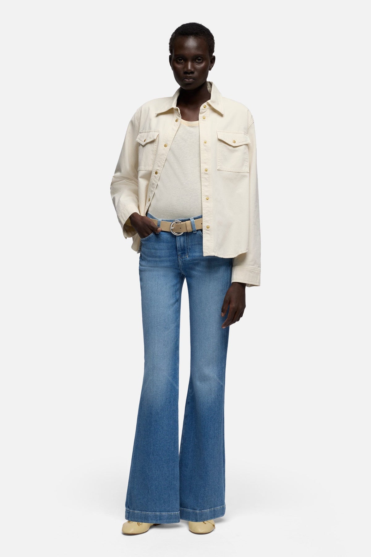 7 For All Mankind Dojo in Slim Illusion Bluehaven mid rise shape fitted through the hips and thighs with a full length flared leg western fashion
