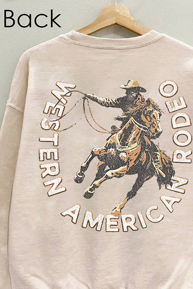 Beige sweatshirt with a graphic of a cowboy on a horse and text 'Western American Rodeo' on a hanger. boltranchstore.com Bolt Ranch Store sweatshirt comfy cotton
