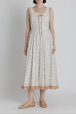 Amber Floral Midi Dress a plaid blue stripe with red floral detail throughout a red gingham trim detail with a tie in the front and back crisscross tie at 