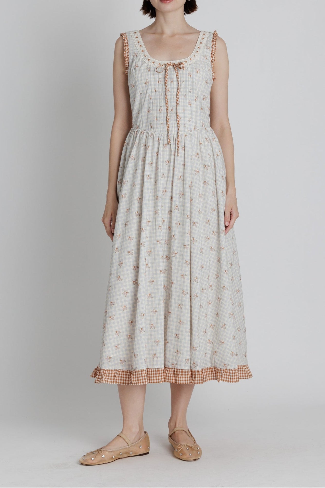 Amber Floral Midi Dress a plaid blue stripe with red floral detail throughout a red gingham trim detail with a tie in the front and back crisscross tie at 