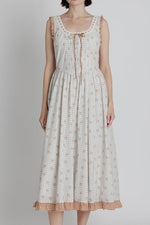 Amber Floral Midi Dress a plaid blue stripe with red floral detail throughout a red gingham trim detail with a tie in the front and back crisscross tie at boltranchstore.com