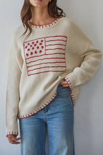  cream-colored knit sweater with a red embroidered American flag design on the front American Womens Flag Pullover usa crewneck 