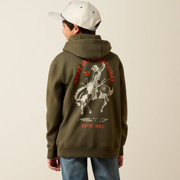 Ariat Youth International Rodeo Hoodie at boltranchstore.com in stock free shipping A boy wearing an olive green hoodie with a large white and red graphic print on the back.