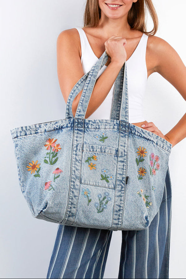 The Perfect Sized Blossom Tote Billy T denim bag zipper Boltranchstore.com free shipping Woman holding a denim tote bag with floral embroidery against a white background