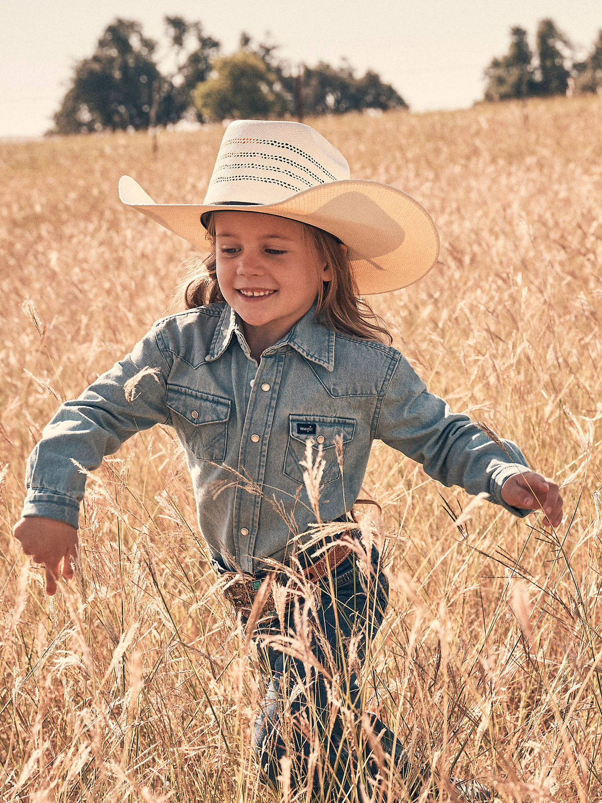 BW1251B Wrangler Kids Cowboy Cut Western Snap Shirt at boltranchstore.com free shipping in stock kids western denim pearl snap button up Child wearing a cowboy hat and denim shirt 