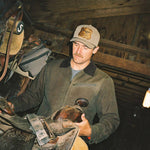 Seager Badge Snapback Olive cap worn outdoors with western workwear cowboy