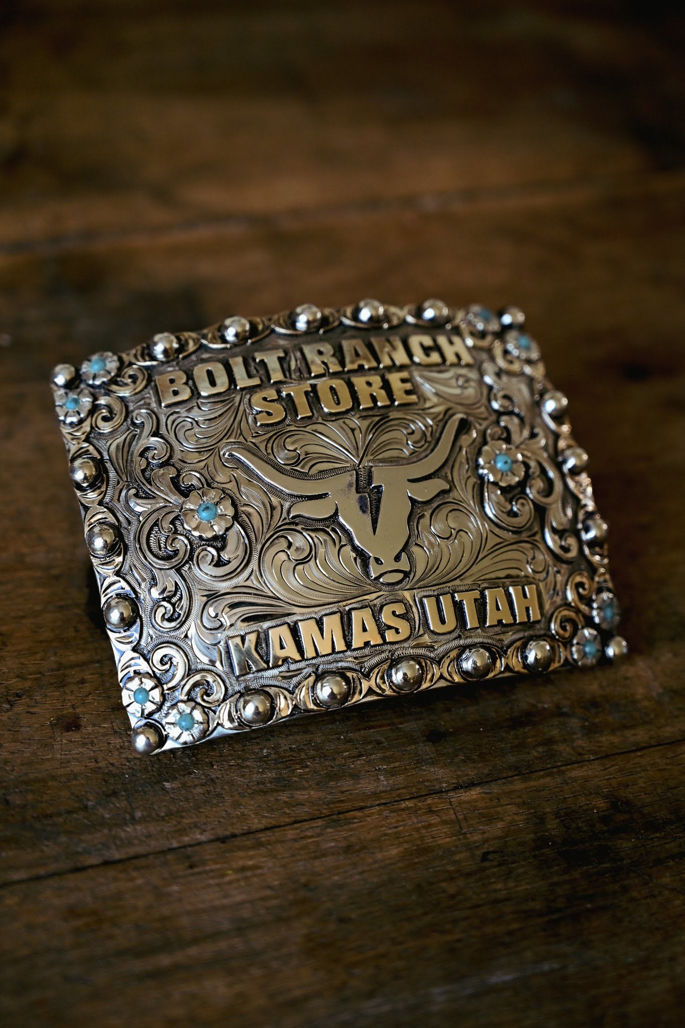 Bolt Ranch Branded Buckle bullhead branded logo with turquoise flowers and scroll designed belt buckle