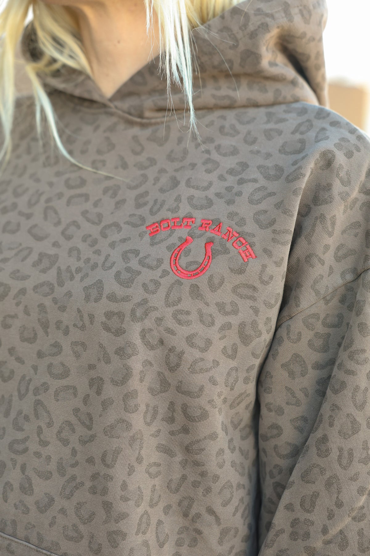 Bolt Ranch Good Luck Collegiate Hoodie womens cheetah leopard print hoodie with red embroidery horse shoe and bolt ranch store logo gear for fall 2026