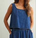 Sleeveless denim top buttons up all the way in the back has a scoop neck 