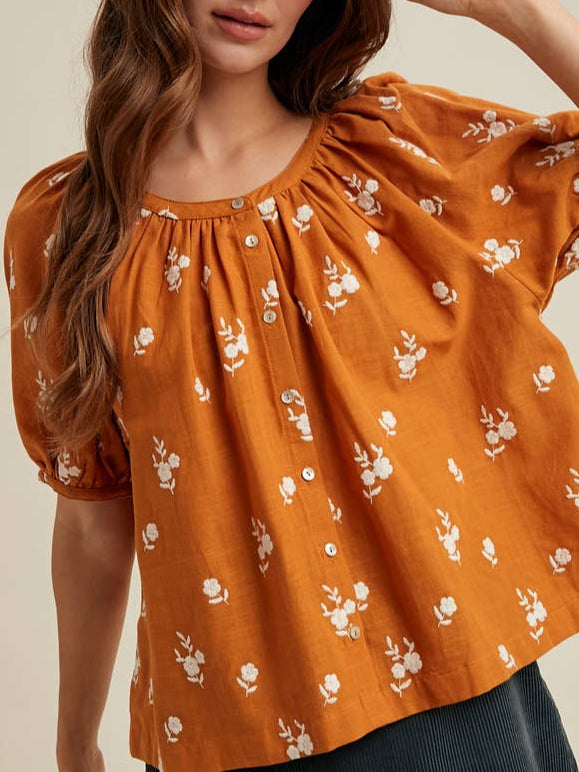 The Fallon Floral Embroidered Button is a auburn colored blouse with white floral patterns available at boltranchstore.com