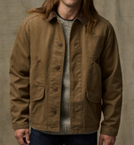 Filson Mens Canvas Outfitter Jacket in Kangaroo is a canvas button up coat with hand pockets and cargo pockets and a corduroy lined collar at boltranchstore.com