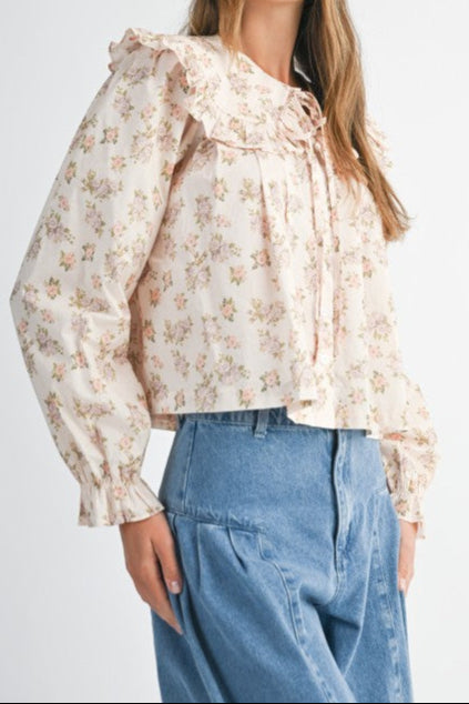 Fran Floral Peter Pan Collared Shirt with a floral, button up, front tie, with a long sleeve with ruffle cuffs