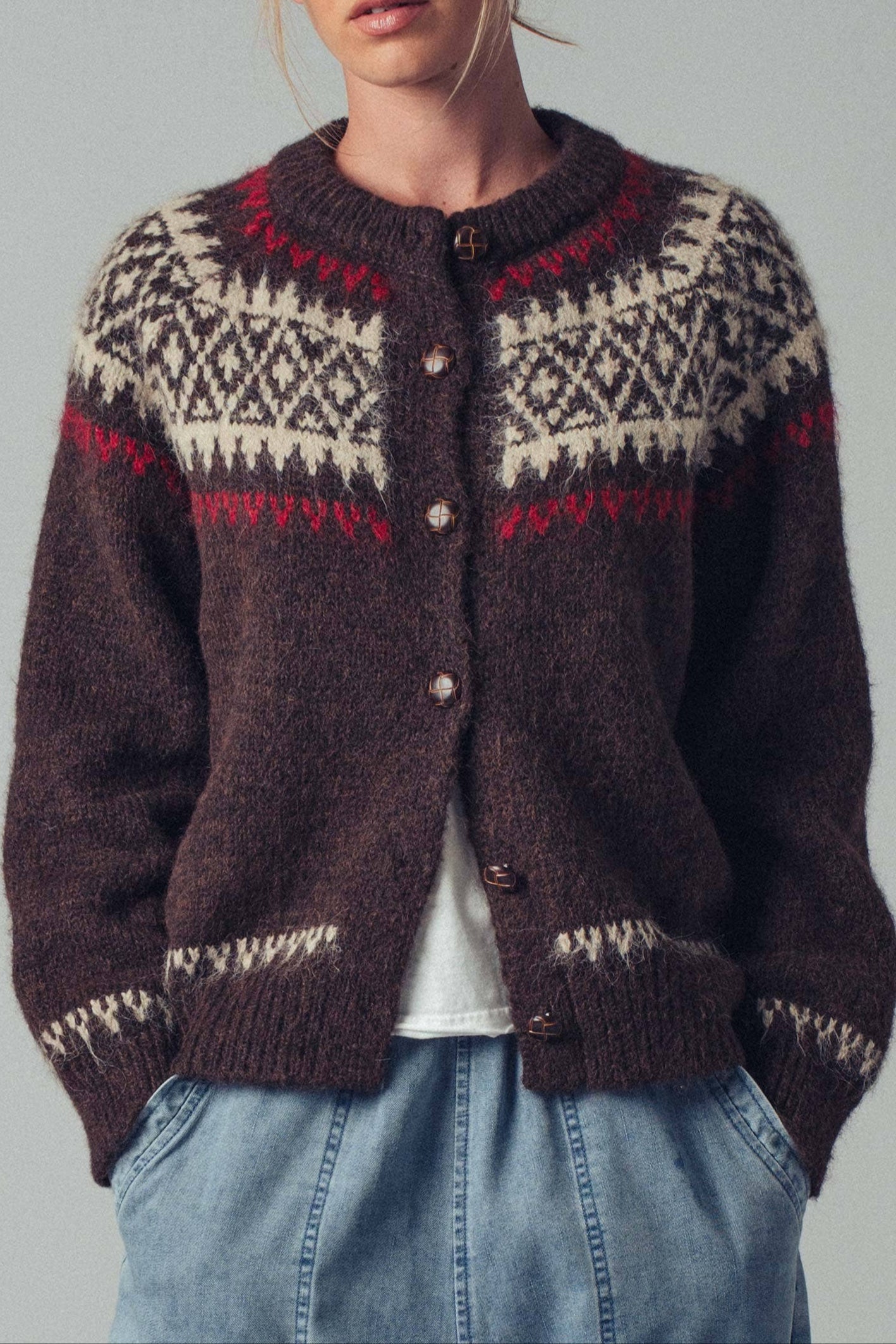 Person wearing a patterned sweater with a plain background cottage core ballerina farms grandma core fisherman