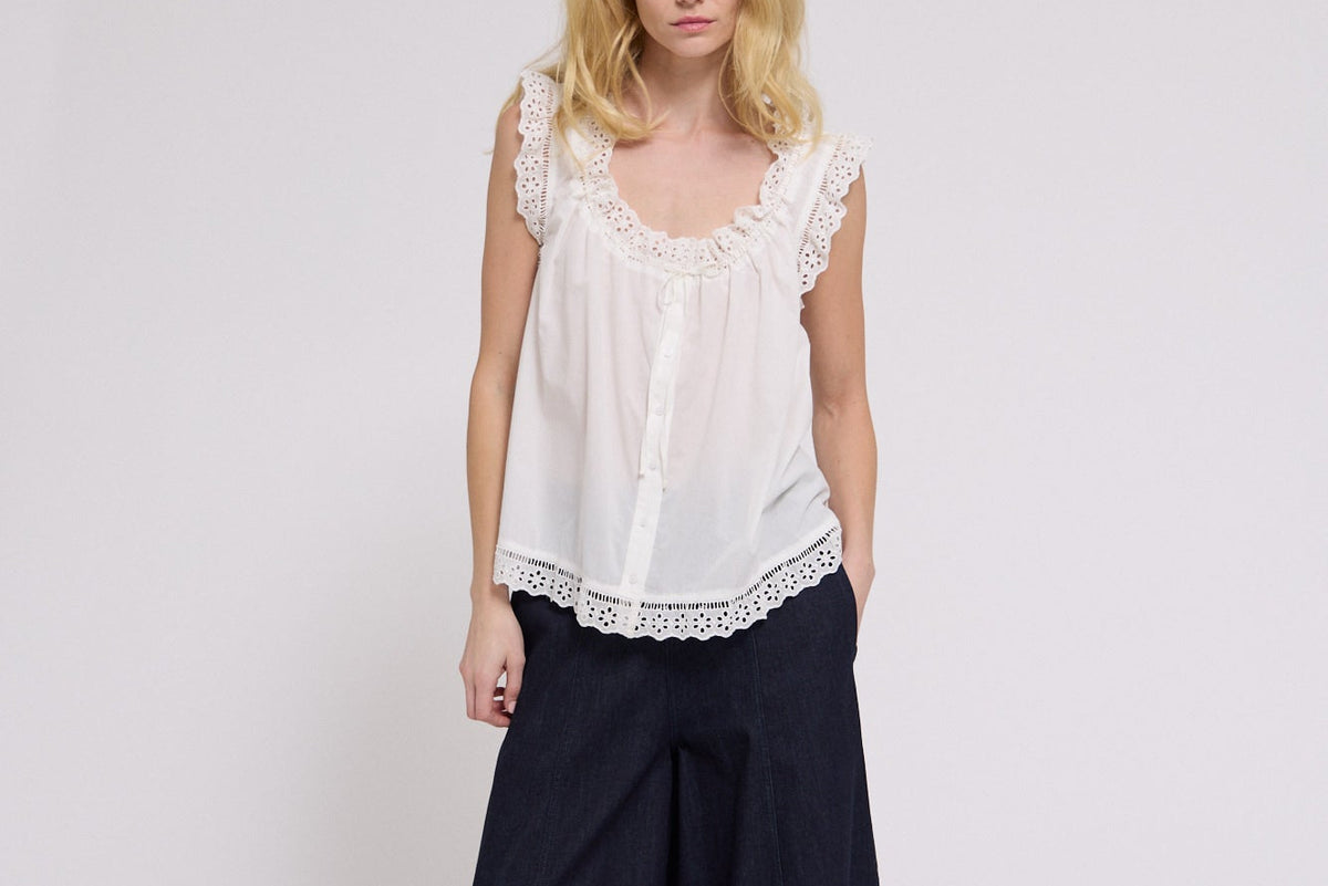 Lace Trim Swing Tank shop at boltranchstore.com Woman wearing a white lace top and black wide-leg pants on a white background