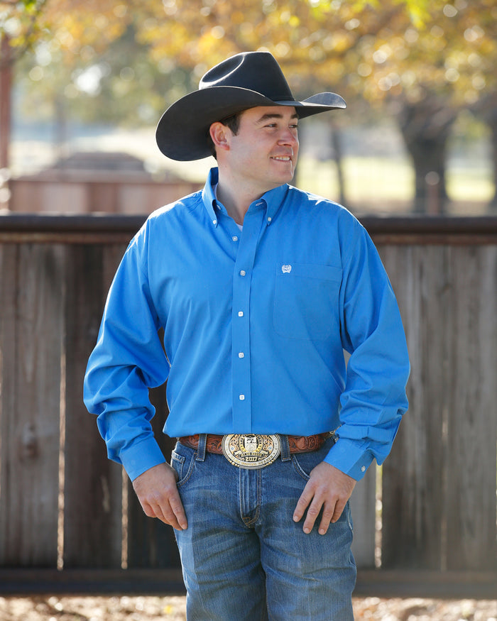 Man wearing a blue shirt and cowboy hat standing outdoors Cinch Mens Solid Blue Shirts at boltranchstore.com rodeo western outfit men shirt solid color