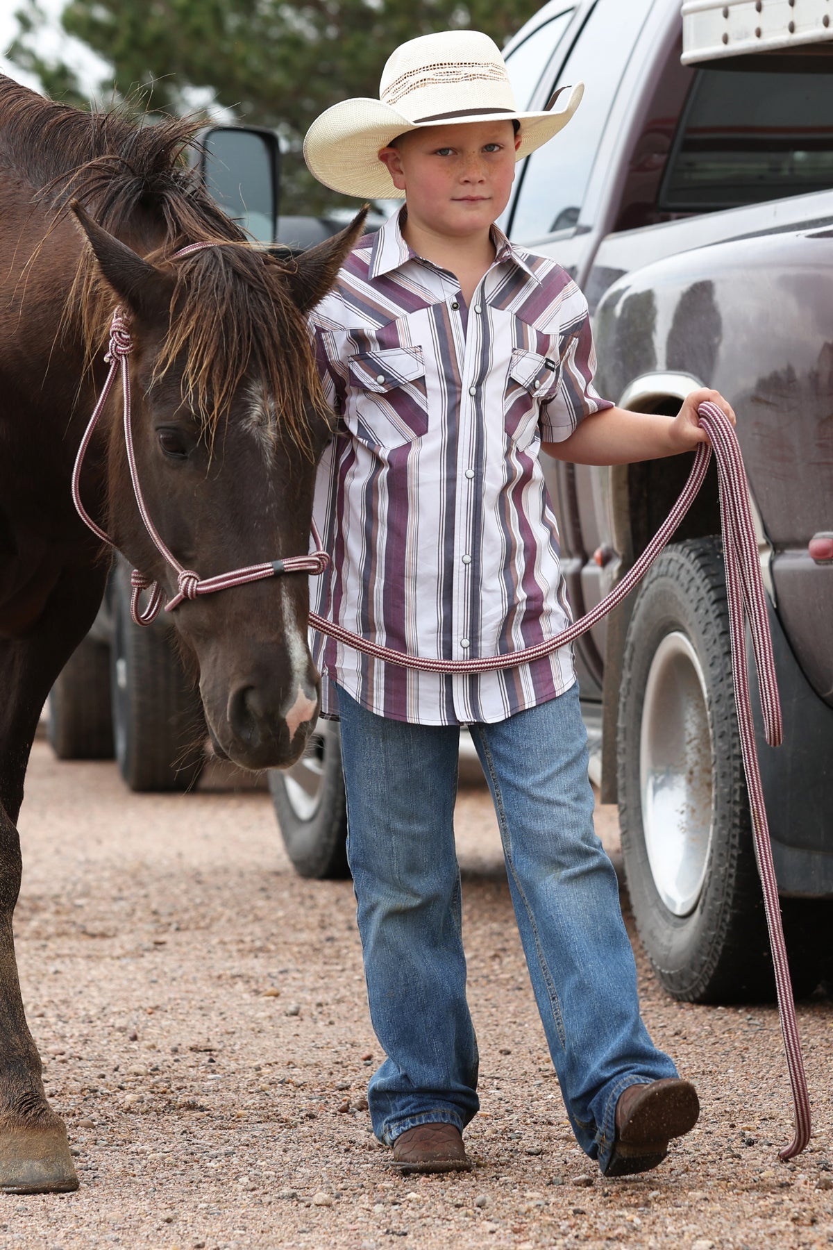 Young boy in a striped shirt cowboy MTW7171002 Cinch Boys Western Shirt AT BOLTRANCHSTORE.COM free shipping in stock 