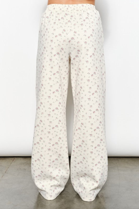 Madison Ditsy Sweatpants in ivory featuring a soft ivory base with a delicate floral ditsy print, elastic waistband with drawstring, and relaxed jogger fit with cuffed ankles available at boltranchstore.com