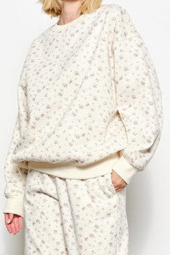Madison Ditsy Sweatshirt featuring a soft ivory fabric with a delicate floral ditsy print, crew neckline, long sleeves, and a relaxed, cozy fit available at boltranchstore.com