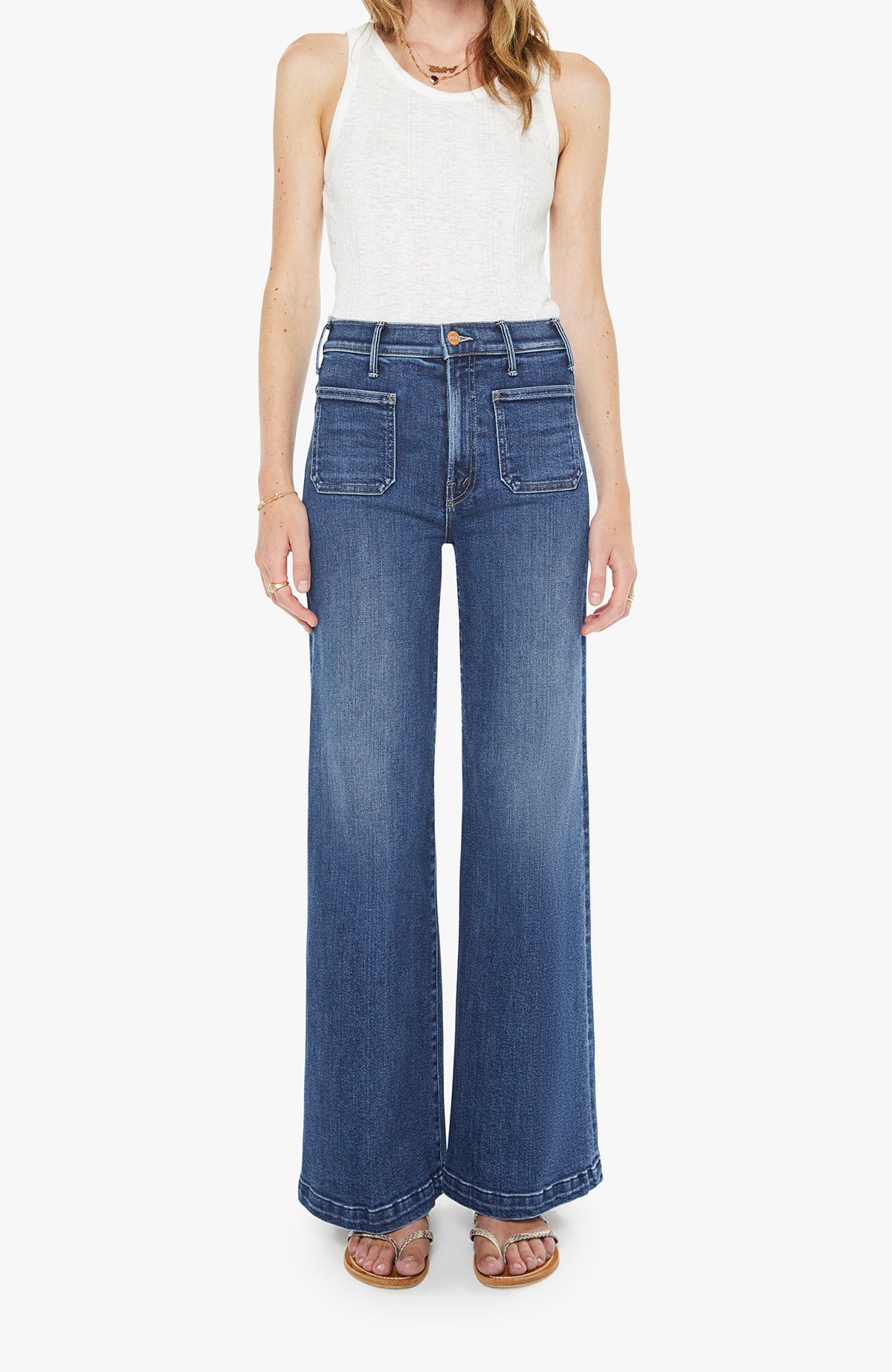 Mother Hustler Roller Patch Pocket Skimp Jean in a dark wash lighter to the knees, front pockets and a bottom hem on the legs where almost anywhere, from casual errands and coffee runs with sneakers and a tee to elevated daily wear with loafers or boots, or even for smart casual evenings a favorite of Addison Rae.