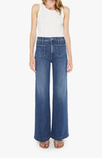 Mother Hustler Roller Patch Pocket Skimp Jean in a dark wash lighter to the knees, front pockets and a bottom hem on the legs where almost anywhere, from casual errands and coffee runs with sneakers and a tee to elevated daily wear with loafers or boots, or even for smart casual evenings a favorite of Addison Rae.