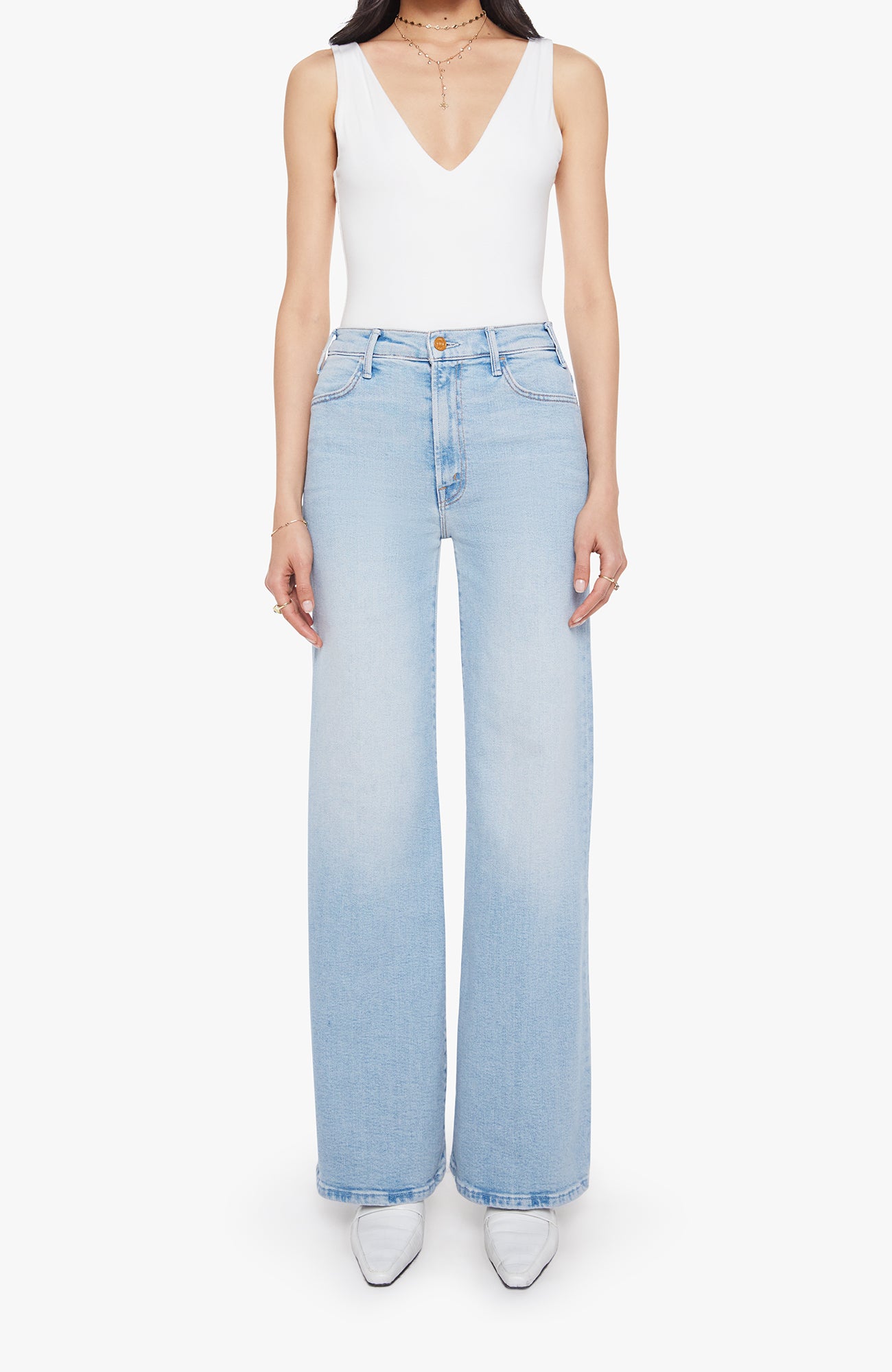 Mother The Hustler Roller Sneak Complete 360 These light-wash jeans feature a clean, modern silhouette with a flattering high-rise waist and a relaxed wide-leg fit. Designed to elongate the leg, they fall straight from the hip with an easy drape and finished hem. Classic five-pocket styling is complemented by subtle back-pocket stitching for a refined touch. Versatile and effortless, this pair pairs perfectly with fitted tanks, bodysuits, or cozy knits for everyday wear.