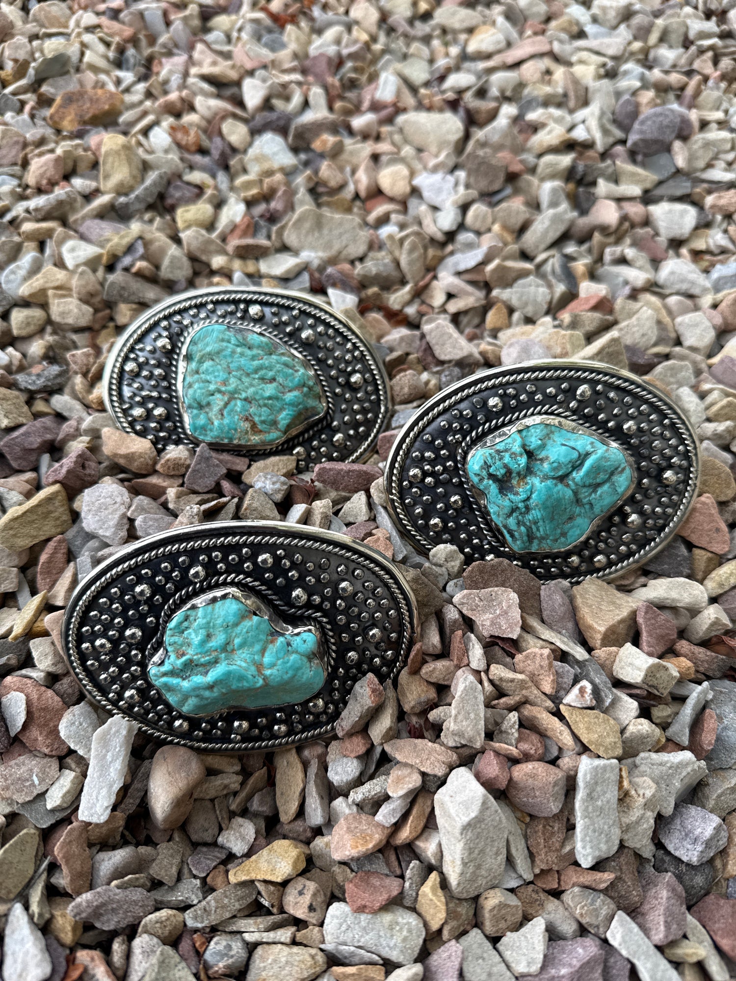 Paige Wallace Oval Turquoise Center Buckle with various sizes of turquoise center with texture and rope detail at boltranchstore.com