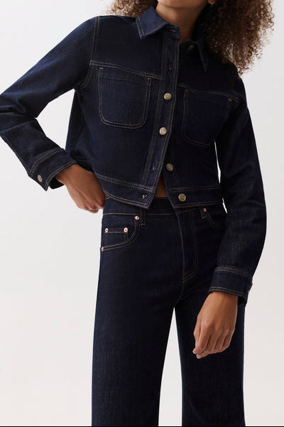 Pistola Leonie Cropped Denim Jacket a cropped jacked in a dark wash, two front pockets, button up, with a collar and long sleeves with button cuffs.
