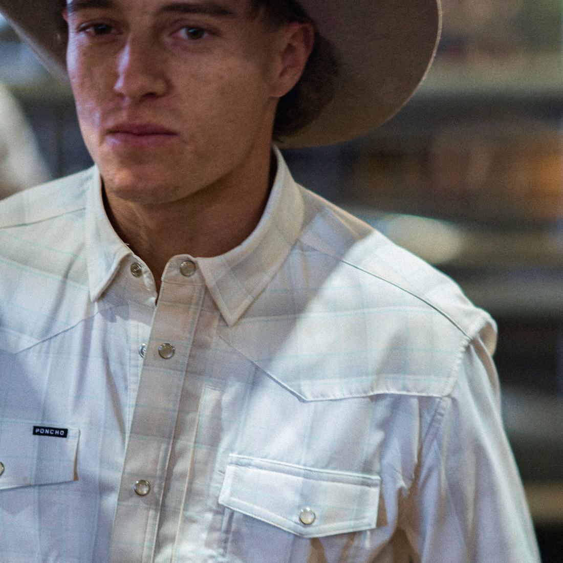 Poncho Mens Kalispell Shirt a long sleeve snap up plaid shirt in gray blue and cream with two snap down front pockets and snap cuffs at boltranchstore.com