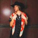 Sendero Rose Dove Bandana Scarf Red Teal draped over the shoulders as a lightweight shawl for rodeo nights