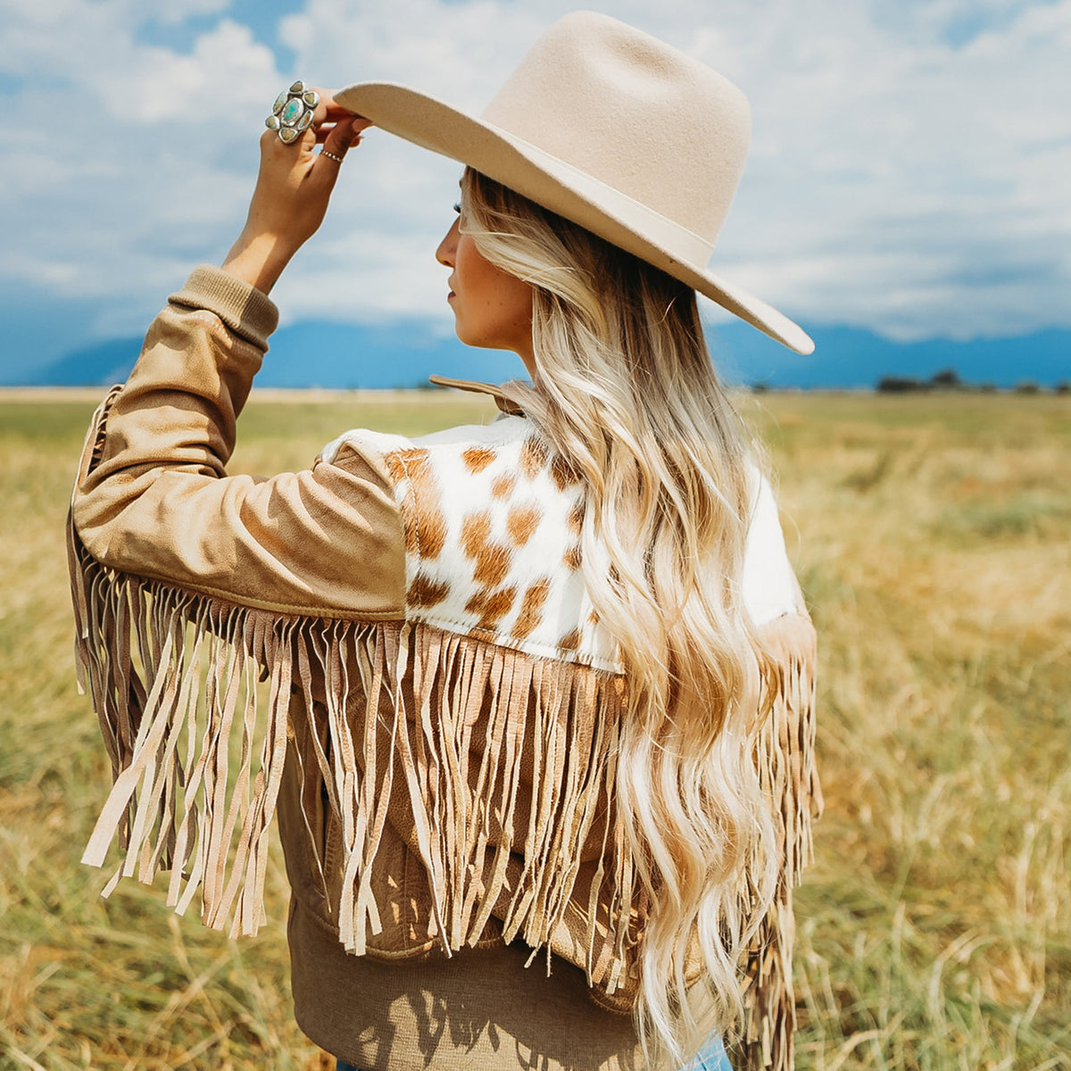STS Ranch Womens Lettie Palomino tan fringe leather jacket paired with a cowboy hat for cowgirl style on the ranch