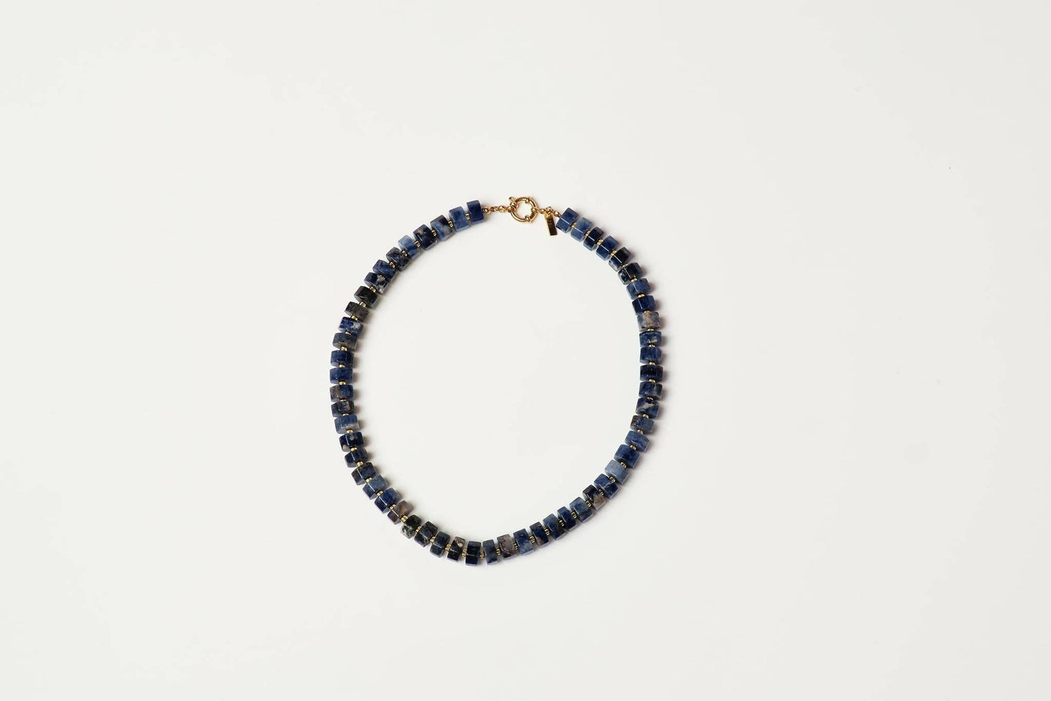A beaded necklace made of small dark blue lapis lazuli stone beads with a gold clasp shop at boltranchstore.com