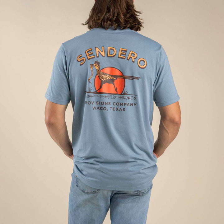Sendero Desert Runner T Shirt at boltranchstore.com free shipping mens tee shirt summer shirt Person wearing a blue t-shirt with 'Sendero' branding on the back