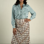 Sendero Womens Dakota Blouse at boltranchstore.com free shipping in stock womens silk western shirt dress up or down style with pants or skirt in sage A woman modeling a light blue satin western-style button-up shirt 