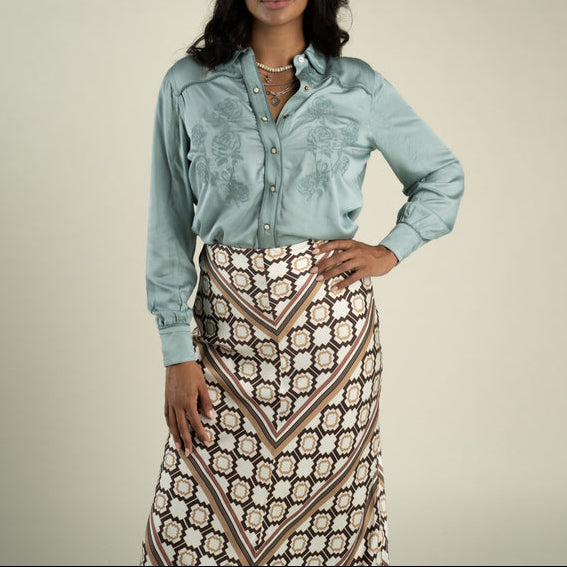 Sendero Womens Dakota Blouse at boltranchstore.com free shipping in stock womens silk western shirt dress up or down style with pants or skirt in sage A woman modeling a light blue satin western-style button-up shirt 
