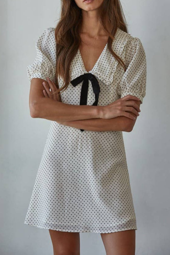 Sue Swiss Dot Print Mini Dress features polka dots on a cream dress with a bow tie front detail at boltranchstore.com