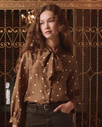The Great Zenith Top Copper Bubble Dot tie neck bow at the collar with button front
